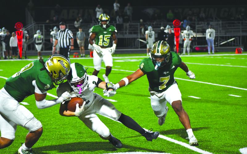 Wesley Branch/The Clayton Tribune. Rabun Gap linebackers Kaylan Brown (left) and Praise Chane (right) close in on a Christ School ball carrier in the Eagles’ 42-0 regular season win over the Greenies on Oct. 17, 2025. Brown announced his commitment to East Tennessee State last week and Chane announced his commitment to Navy.