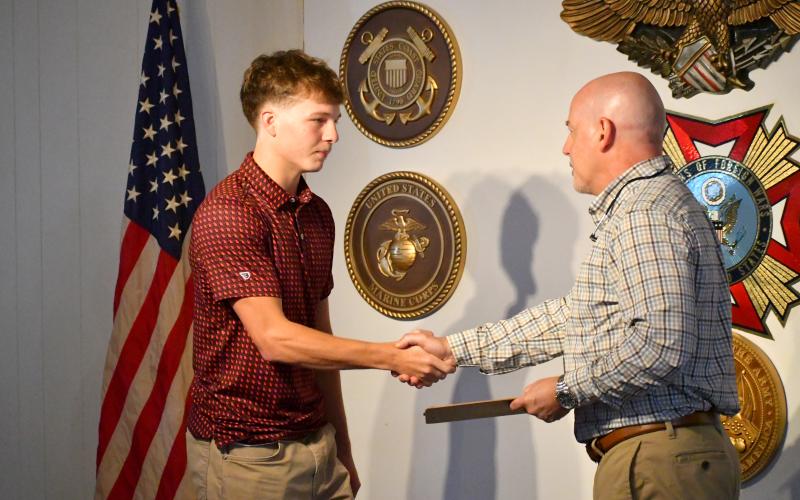 Wesley Branch/The Clayton Tribune. Huey Blalock (left) shakes hands with Roger Glenn after the recent Rabun County High School graduate’s oath of service at VFW Post 4570 in Clayton on June 24. Blalock will head to the Naval Academy to continue his basketball and academic careers after completing the Naval Academy’s 10-month preparatory program, NAPS.