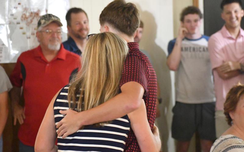 Wesley Branch/The Clayton Tribune. Huey Blalock hugs his mother, Katrina, after his oath of service at VFW Post 4570 in Clayton on June 24. Blalock helped lead the Wildcats to a 30-2 record and state title this season in boys basketball, earning a scholarship from Navy.