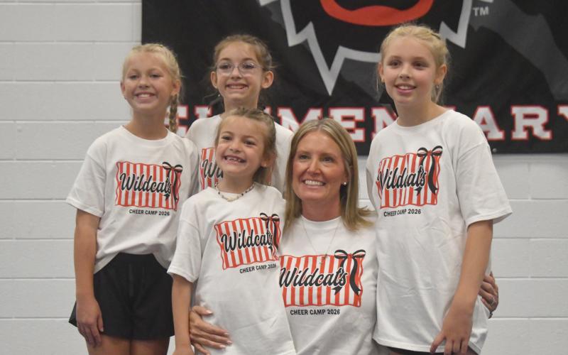 Wesley Branch/The Clayton Tribune. ampers pose with Rabun County head cheer coach Cristina Weber following the final day of the Rabun County cheer camp. This year will be Weber’s final season as the head coach of the Wildcat cheer team, she said.
