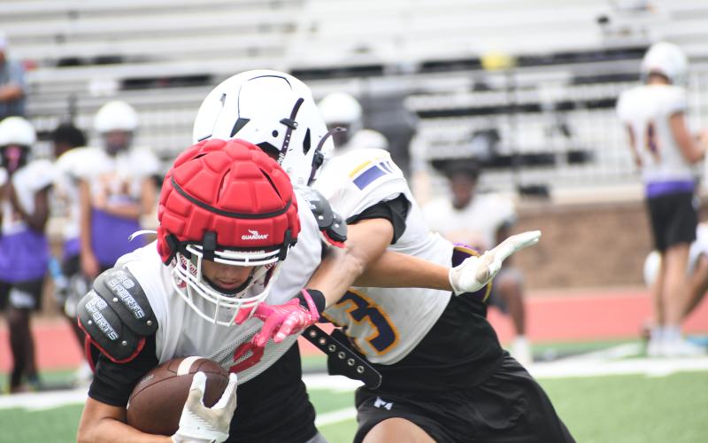 Wesley Branch/The Clayton Tribune. Rabun County rising senior wide receiver Reed Lafevers brings in a pass from quarterback Cooper Kowalsky through contact during Rabun County’s July 14 padded camp session. Lafevers was second on the Wildcats in receptions and yards a season ago and led the team in receiving touchdowns.