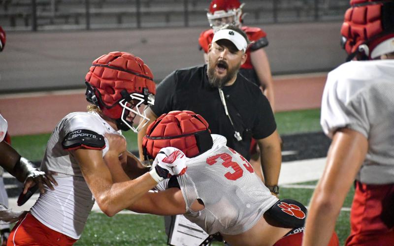 Wesley Branch/The Clayton Tribune. Rabun County’s Hayden Cannon (left) and Brock Brady (right) battle for positioning during a drill at Rabun County’s “Midnight Madness practice” on July 27. The late night practice was the first day that GHSA football teams were allowed to practice in full pads.