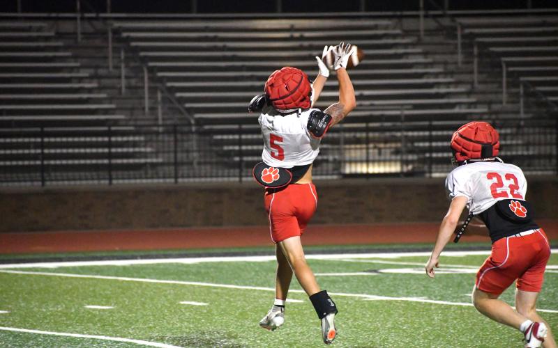 Wesley Branch/The Clayton Tribune. Rabun County sophomore Wyatt English hauls in a pass during one-on-one drills at Rabun County’s July 27 “Midnight Madness” practice. Following the late practice, the Wildcat players and coaches hiked three miles up Currahee Mountain, a RCHS football tradition.