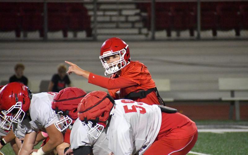 Wesley Branch/The Clayton Tribune. Rabun County quarterback Cooper Kowalsky directs his team before a play during Rabun County’s “Midnight Madness” practice on July 27. Kowalsky is heading into his first season as Rabun County’s starting quarterback.