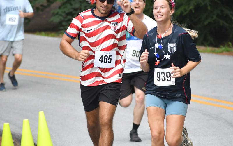 Enoch Autry/The Clayton Tribune. Mayson Atkinson and Lee Ann Passarella show off their colorful patriotism during the 5K.