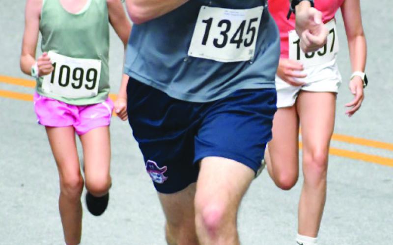 Enoch Autry/The Clayton Tribune. Alden Thaxton won this year’s Rabun Ramble 10K. Here he finishes in front of 5K runners.