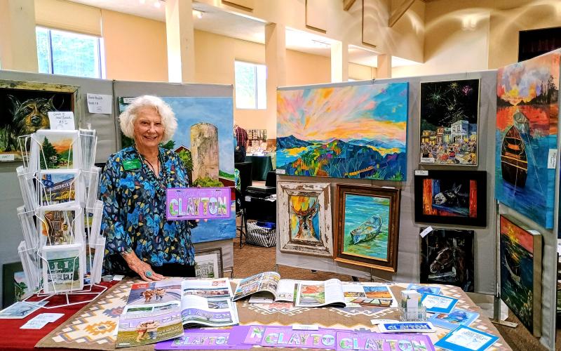 Megan Horn/The Clayton Tribune. North Georgia Arts Guild member Diane Rush showcases her unique works of art, which include front license plates featuring Clayton. Rush is known for her artwork depicting local county landmarks.