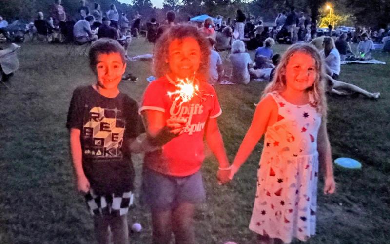 Megan Horn/The Clayton Tribune. Wyatt Pedeski, 6; Addison Richardson, 7; and Jenna Bleckley, 6, hold sparklers during the July 1 inaugural Clayton event.