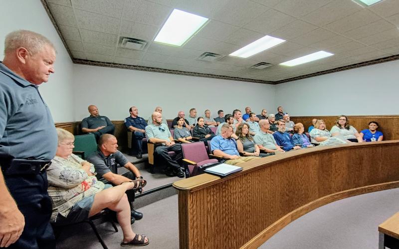 Megan Horn/The Clayton Tribune. Several employees and officials with Rabun County EMS attend a June 30 Board of Commissioners special called meeting about discontinuing county EMS interfacility transports from Mountain Lakes Medical Center. EMS Director Mike Carnes is pictured far left.