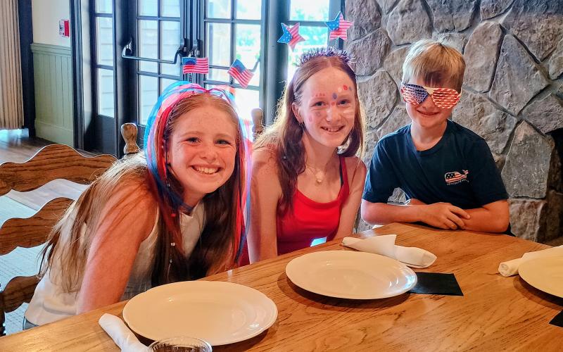 Megan Horn/The Clayton Tribune. Juli Althausen, 12; Emma Althausen, 14; and Matthew Althausen, 7, from Sugar Hill, Ga., enjoy the Independence Day weekend barbecue menu on July 4 at the Dillard House: A Mountain Farm Resort.