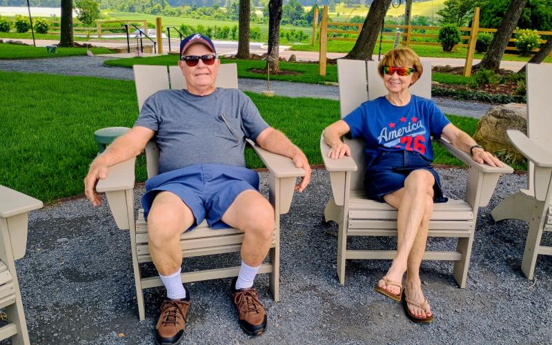 Megan Horn/The Clayton Tribune. David and Linda Braddock from South Carolina have been patrons of the Dillard House since 1971. They enjoy a relaxing time by the fire pit in the OakLawn on Saturday, July 4.