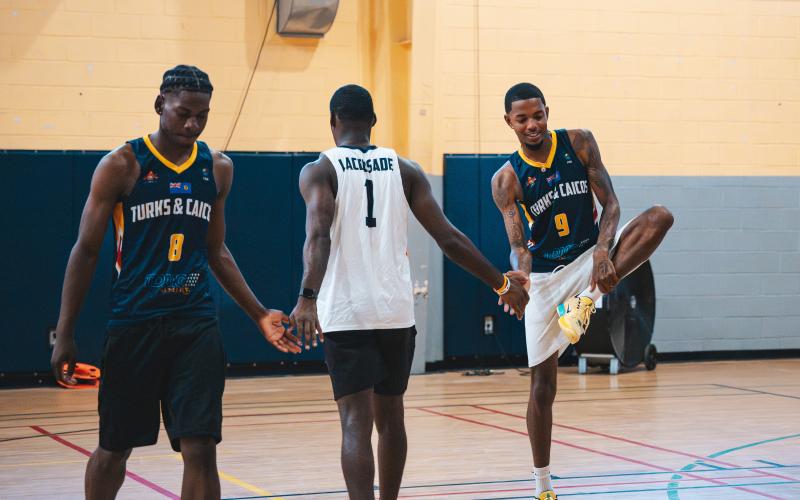 Submitted photo. Recent Rabun Gap graduate RJ Lacossade (center) high fives teammates during a practice with the Turks &amp; Caicos national team in preparation for the 2029 FIBA AmeriCup Caribbean Pre-Qualifiers. Lacossade, who is signed with Southern Wesleyan University, was born in Turks &amp; Caicos and left his home country at the age 14 to chase his basketball dreams.