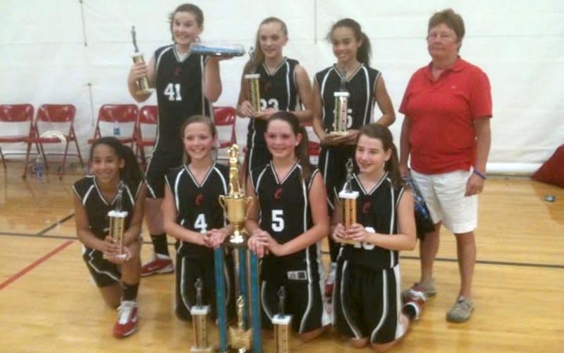 Submitted Photo. Former Rabun County coach and teacher Janice Wayne (far right) poses with her middle school team after winning an offseason tournament. Wayne’s RCMS girls basketball teams won several championships during her tenure.