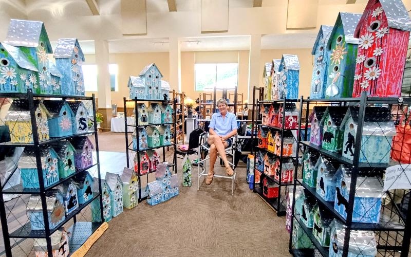 Megan Horn/The Clayton Tribune. Jenny Moore, a.k.a the “The Flighty Birdhouse Lady,” displays her colorful and intricate birdhouses at last weekend’s Painted Fern Art Festival presented by the North Georgia Arts Guild.