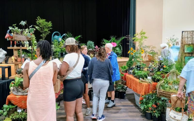 Megan Horn/The Clayton Tribune. Many people attending the Painted Fern Art Festival last weekend were drawn to the greenery of Melissa Heiden’s work. Heiden is the owner, buyer and designer for Harvest Moon Antiques, Garden &amp; Art.