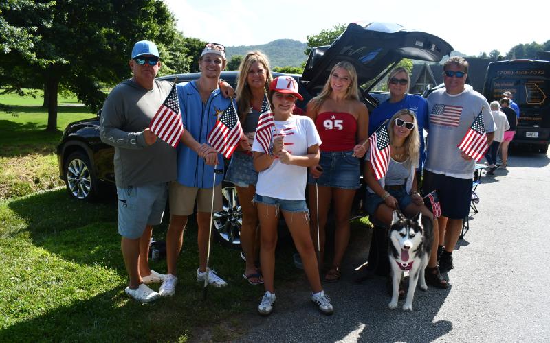 Megan Horn/The Clayton Tribune. Jared Carr, Jon Carr, Tasha Carr, Gina Carr, Justin Carr, Adley Carr, Adalynn Carr and Abbie Carr with their dog, Korra, enjoy Sky Valley’s Independence Day events on July 3. They were at the event to honor their late father, David Carr, who loved Sky Valley. Their mother is Liz Carr. Attending Sky Valley events has been a family tradition.