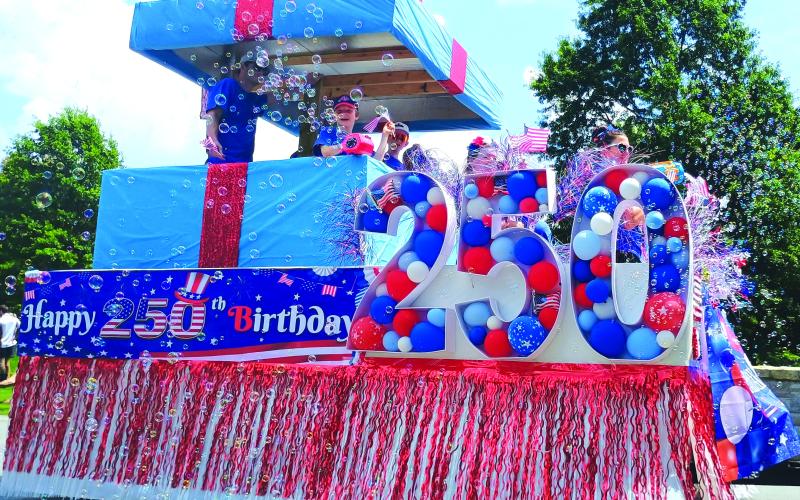 Megan Horn/The Clayton Tribune. This “Present of Freedom” float by O.L.I. Home Solutions was the parade winner in the Sky Valley Independence Day grand parade on Friday, July 3. The day was filled with fun, food and a fireworks show.
