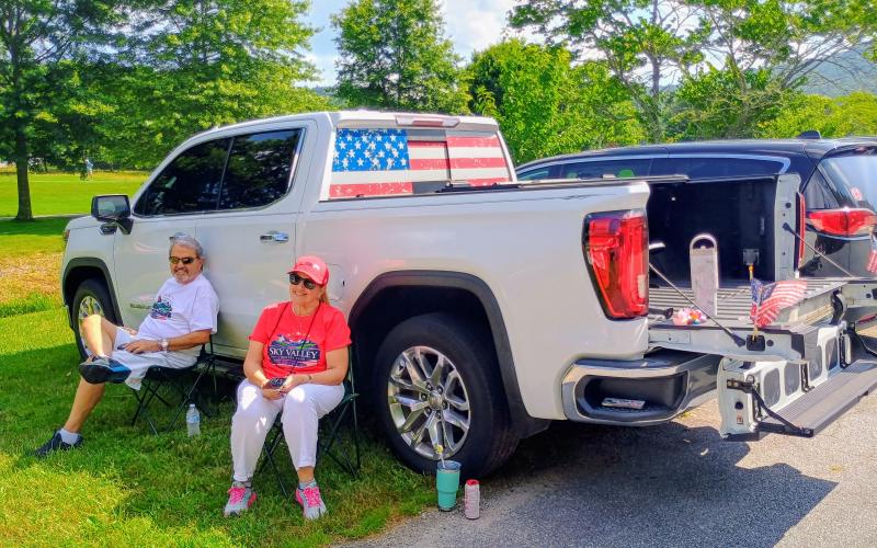 Megan Horn/The Clayton Tribune. Rafael and Dolly Imbert are patriotic in Sky Valley as they prepare to watch the annual parade.