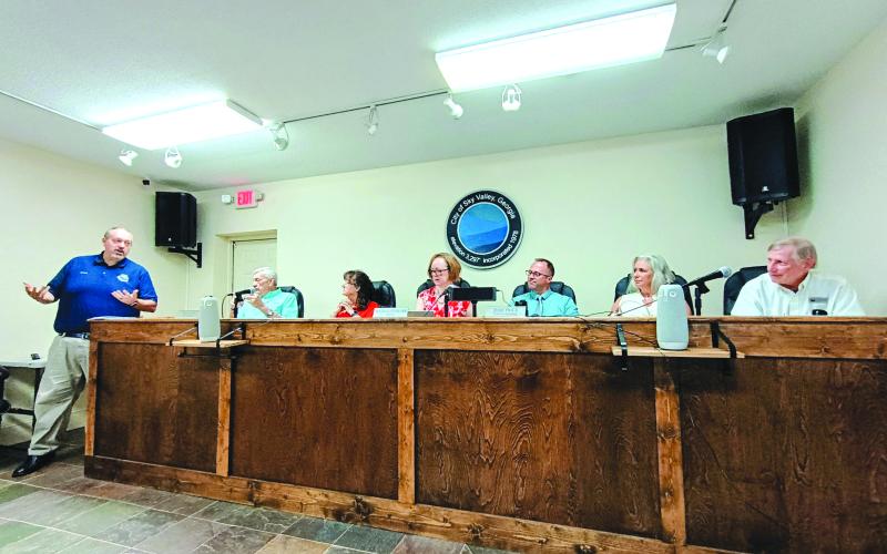 Megan Horn/The Clayton Tribune. Sky Valley City Manager Jason Streetman, left, gives his last report as city manager at the July 21 regular council meeting. Pictured right are Council Member Tony Allred, Council President Beth Pence, Mayor Benita Cotton-Orr, and council members Jesse Price, CareySue Beasley and Jim Curtis. Streetman’s last day as Sky Valley’s city manager is July 31. His start date as Clarkesville city manager is Aug. 3.