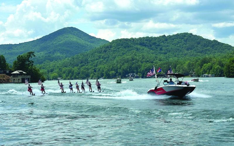 Submitted photo. The Ski Patriots annually celebrate America’s freedom by skiing with American flags attached to their life preservers as they journey around the edges of Lake Burton. This year the Ski Patriots performed on July 5.