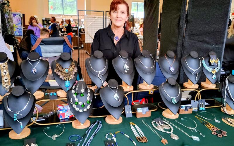 Megan Horn/The Clayton Tribune. Jewelry designer Diana Winuk features her creative jewelry “Artistically Designed by D” during last weekend’s Painted Fern Art Festival. Winuk said much of her inspiration comes from her love of horses.