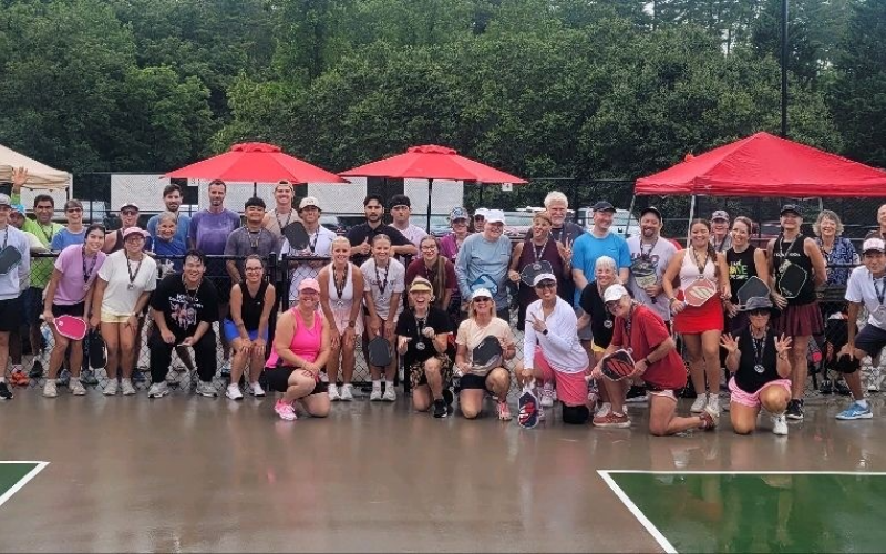 Submitted. Dozens of pickleball players from Rabun County and surrounding communities braved the showers to compete in a Team Challenge tournament on Saturday, July 25. The players and spectators contributed $1,000 to the Sid Weber Cancer Fund from the pickleball fundraiser. The pickleball courts on the Rabun County Recreation Department property in Tiger have been used extensively since their opening.