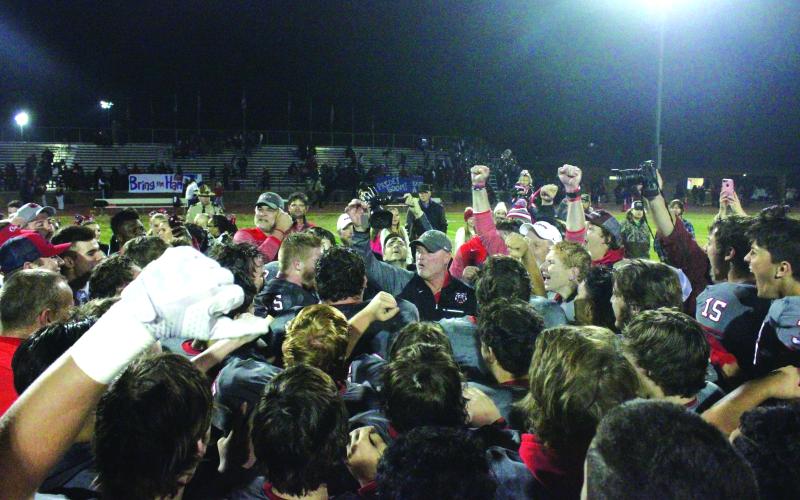 Wesley Branch/The Clayton Tribune. Rabun County head football coach Lee Shaw (center) celebrates with his Wildcat team after a 23-12 win in the state semifinals over Brooks County to send RCHS to the 2017 state title game. Shaw won 70 games as RCHS’ head coach and five consecutive region titles. Shaw will travel up from South Georgia with his Metter team to Tiger on Aug. 28 for Rabun County’s season opener.