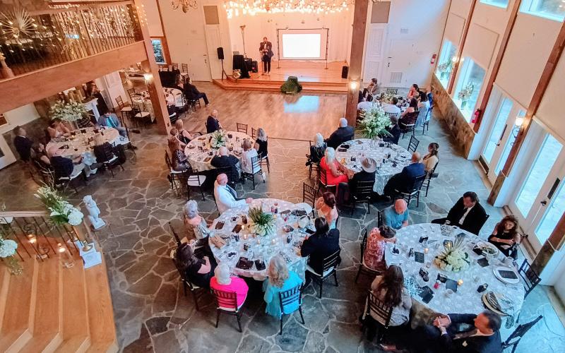Megan Horn/The Clayton Tribune. Aaron Hooker plays a worship set during the Choices Pregnancy Center Heartbeat Gala on Aug. 1 at Chota Falls. Gala guests sang along and praised God with hands in the air. The venue was beautifully lit and decorated.