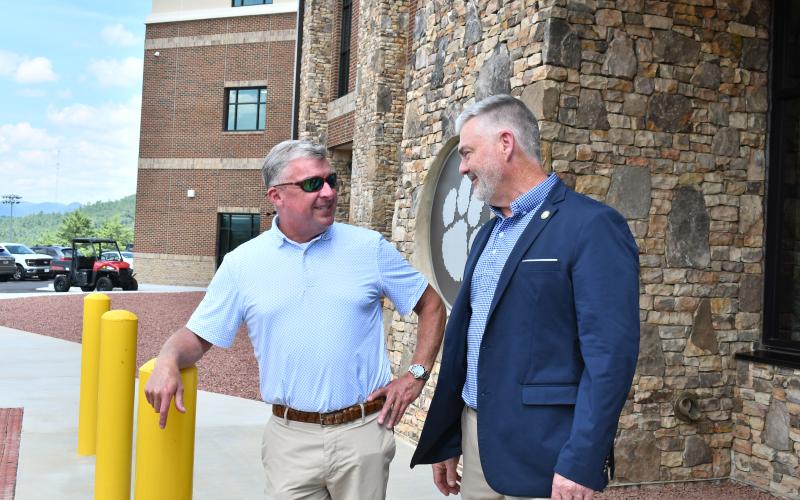 Megan Horn/The Clayton Tribune. Rabun County Board of Education Member Allyn Stockton, left, talks to District 10 State Rep. Victor Anderson prior to the ribbon cutting celebration for the new Rabun County High School Academic Building on July 31.