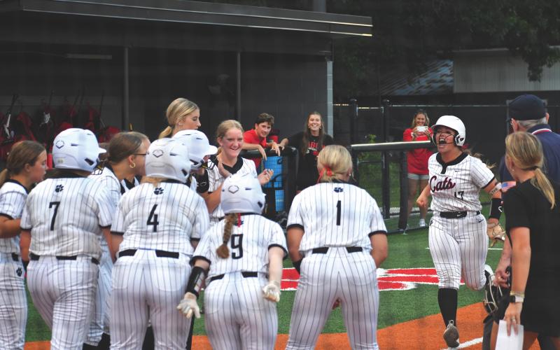 Wesley Branch/The Clayton Tribune. The Rabun County softball team celebrates River Evans’ go-ahead grand slam in the bottom of the sixth inning of the Wildcats’ 15-14 win against East Jackson on Aug. 3. Evans, a junior, went 3-for-4 on the night with a single, double and grand slam.