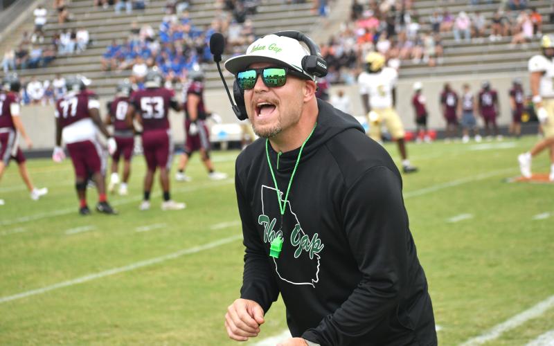 Wesley Branch/The Clayton Tribune. Rabun Gap head football coach Derek White directs his team on the sideline during Rabun Gap’s Aug. 14 scrimmage versus Westside (S.C.). RGNS will face Venice (Fla.) on Aug. 21 at home to open the season.