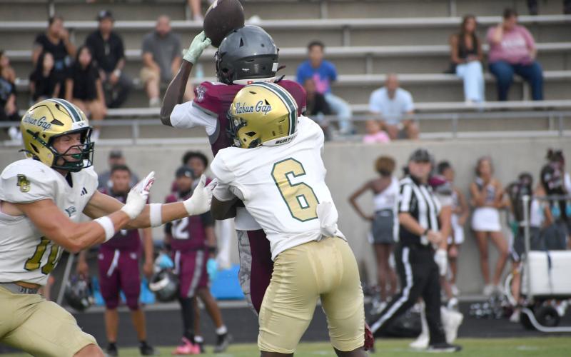 Wesley Branch/The Clayton Tribune. Rabun Gap defensive back Elias Willingham (center) breaks up a pass during Rabun Gap’s August 14 scrimmage versus Westside (S.C.). Willingham and the Eagles’ secondary will have the test of slowing down four-star wide receiver Tyree Mannings on Aug. 21 when RGNS faces Venice High School.