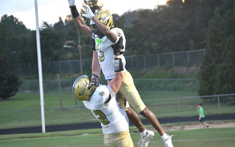 Wesley Branch/The Clayton Tribune. Rabun Gap offensive lineman Wilder Brasher lifts wide receiver Joshua Davis in the air in celebration after Davis’ 60-yard touchdown reception during Rabun Gap’s scrimmage versus Westside (S.C.) on Aug. 14. Davis’ long touchdown grab from quarterback Grayson Clary tied the scrimmage, 13-13.