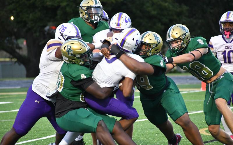Wesley Branch/The Clayton Tribune. Rabun Gap’s Segun Alexander (left) and Isaac Lukuni (right) bring down Christian Brothers quarterback Nick McClellan in the Eagles’ 59-49 loss to the Cadets on Oct. 3, 2025. Alexander, a four-star Notre Dame commit and Lukuni, a four-star recruit in the 2028 class, will help lead the RGNS defense again this season.