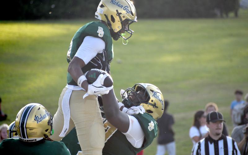 Wesley Branch/The Clayton Tribune. Rabun Gap offensive lineman Ashton Thompson (right) lifts wide receiver Joshua Davis (center) in celebration after Davis hauled in a 7-yard touchdown pass from Clary. Davis caught three passes for 27 yards and a TD in the 42-40 overtime loss.
