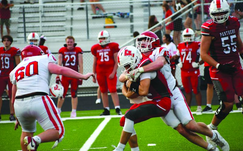 Enoch Autry/The Clayton Tribune. Rabun County senior defensive lineman Mack Williams (45) sacks Franklin (N.C.) Panthers’ quarterback Anderson Terrell during the Wildcats’ scrimmage game on Aug. 14 in North Carolina.