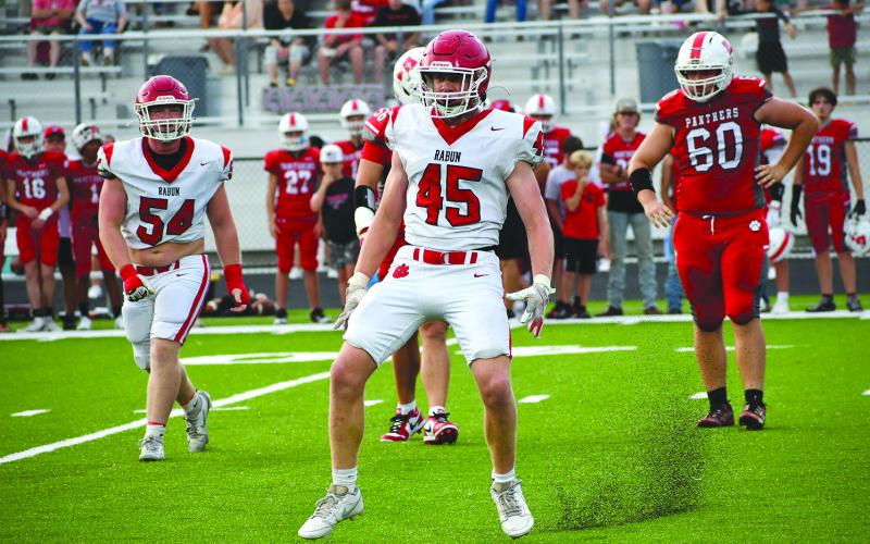 Enoch Autry/The Clayton Tribune. Rabun County senior defensive lineman Mack Williams (45) sturs up pebbles from the new turf at the Franklin, N.C., stadium as he reacts after sacking the Panthers’ quarterback Anderson Terrell.