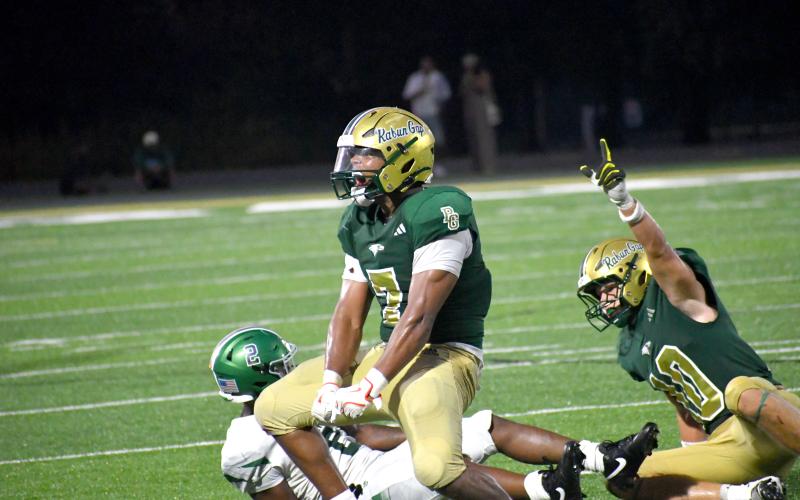 Wesley Branch/The Clayton Tribune. Rabun Gap linebacker Praise Chane (center) celebrates after making a tackle for a loss on third down during Rabun Gap’s 42-40 overtime loss on Aug. 21. Chane, a senior, is committed to the Naval Academy.