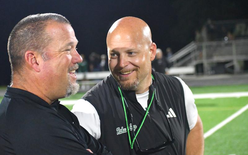 Wesley Branch/The Clayton Tribune. Rabun Gap head football coach Derek White (right) and Venice head football coach John Peacock (left) talk after the teams’ overtime battle to open the season, which Venice won, 42-40. Peacock and the Indians are one of the top programs in Florida High School football.