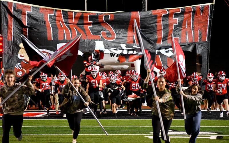 Wesley Branch/The Clayton Tribune. Rabun County High School’s football team runs onto the field before its second-round playoff game versus Berrien last season. The Wildcats enter 2026 following a 10-3 record and run to the state quarterfinals a season ago.