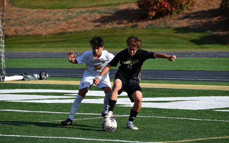 Photo by Wesley Branch/The Clayton Tribune. Rabun Gap’s Theodor Fricke fights off a Carmel Christian defender for the ball in the Eagles’ playoff loss to the Cougars last season. Fricke will be one of RGNS’ key returners this season, head coach JC Gonzalez said.