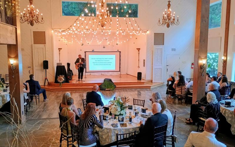 Megan Horn/The Clayton Tribune. Aaron Hooker plays a worship set during the Choices Pregnancy Center Heartbeat Gala on Aug. 1 at Chota Falls.