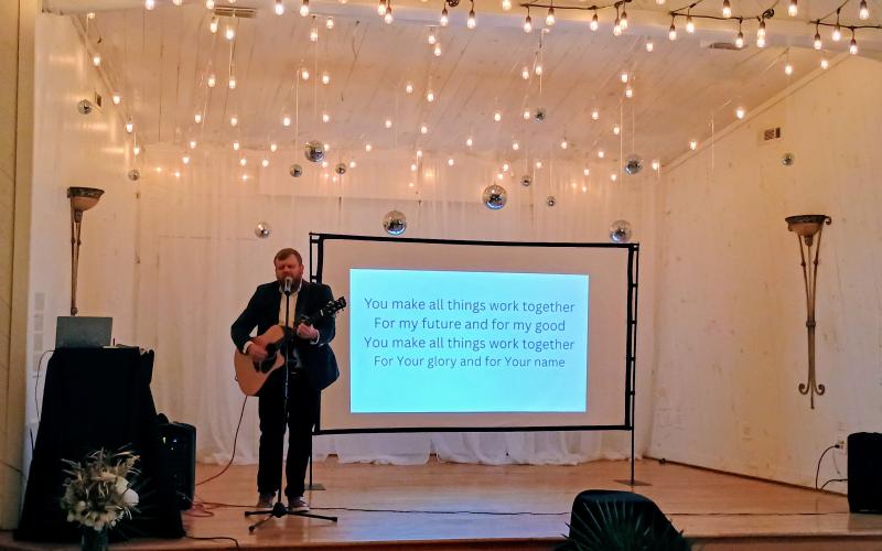 Megan Horn/The Clayton Tribune. Aaron Hooker plays a worship set during the Choices Pregnancy Center Heartbeat Gala on Aug. 1 at Chota Falls.