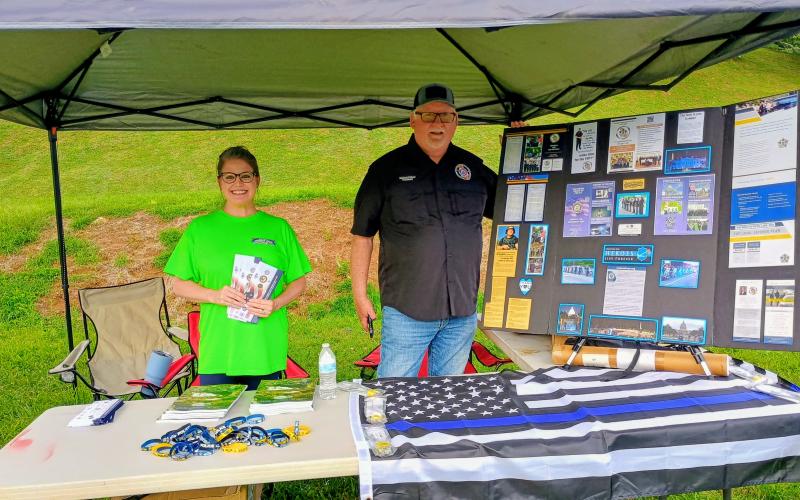 Megan Horn/The Clayton Tribune. Georgia State Fraternal Order of Police (FOP) was one of many organizations present during National Night Out (NNO) in Sky Valley on Tuesday, Aug. 4. Pictured are Sky Valley Deputy Clerk and city Tax Commissioner Summer Murphy and Michael Palmer, representative of North Georgia Mountains Lodge #112 of the Georgia State Fraternal Order of Police (FOP).
