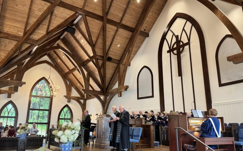 Photo courtesy Susan Respess. On Sunday, July 26, the congregation met for the first time in the mostly completed new sanctuary that will have a ribbon cutting and formal dedication Aug. 2. The Rev. Don Barber, pastor, on the left, is assisted by the Rev. Dr. Tom Leland and the Rev. Dr. John Wyatt to his right.