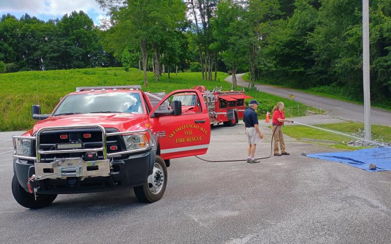 Megan Horn/The Clayton Tribune.  Firefighters for the Sky Valley-Scaly Mountain Volunteer Fire Rescue Department spend time with community members.