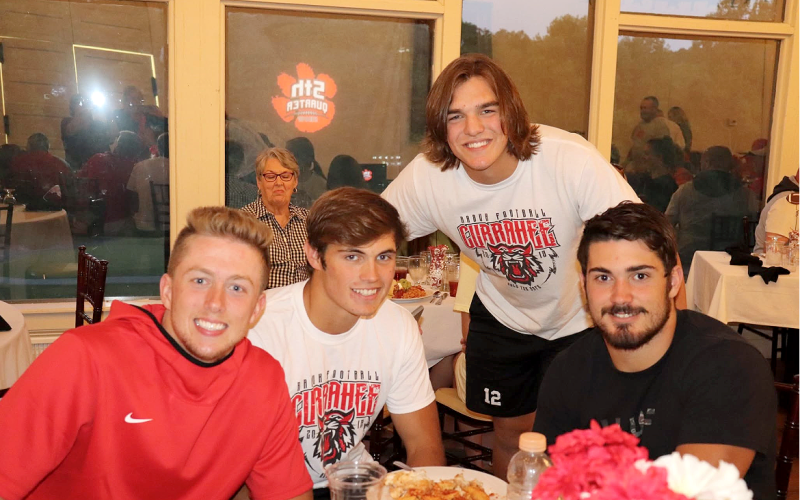 Photo courtesy Von Watts. From left, Braxton Hicks, Hoff Windham, Gunner Stockton and Mason Sprinkle pose for a photo during an episode of the “Fifth Quarter Show” at Mama G’s Italian Restaurant. The show was first held at Mama G’s before being moved to Wildcat Grill years later.