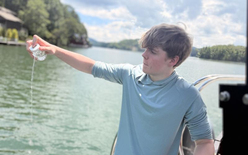 Submitted photo. Henry Dumas collects water from Lake Burton, which he will take back to test for E. Coli levels in the IDEXX laboratory on the TFS campus.