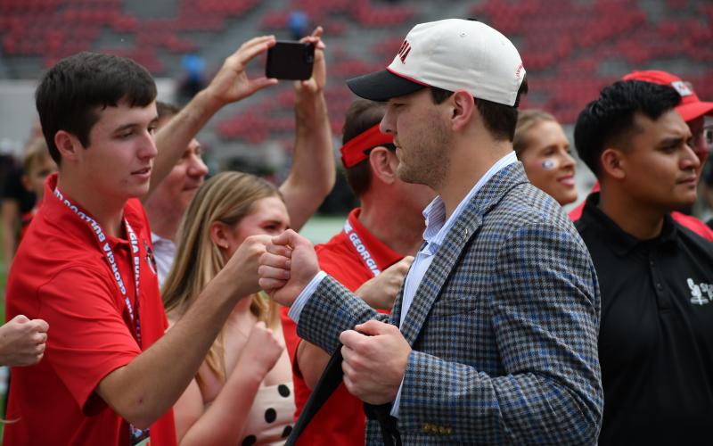 Wesley Branch/The Clayton Tribune. Starting quarterback Gunner Stockton is greeted by fans and fellow students during his “Dawg Walk” prior to the Ole Miss game in Athens on Oct. 18, 2025.