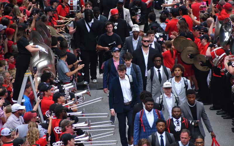 Wesley Branch/The Clayton Tribune. Gunner Stockton (center, wearing cap) joins his Georgia teammates for the “Dawg Walk” before the Bulldogs take on Austin Peay on Sept. 6, 2025, in Athens.